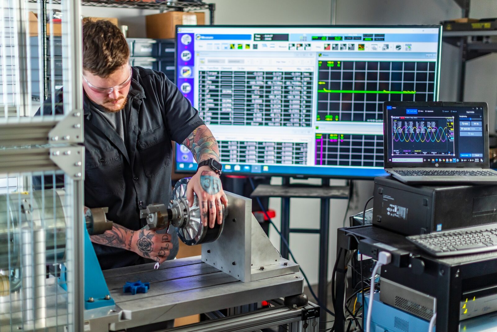 Linear Labs technician testing HET motor with monitoring systems